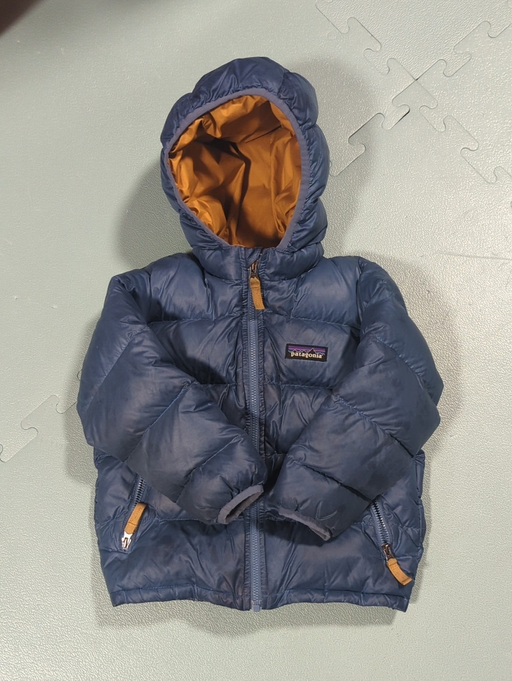 Patagonia Navy Sweater Puffer Jacket with Orange Hood Lining